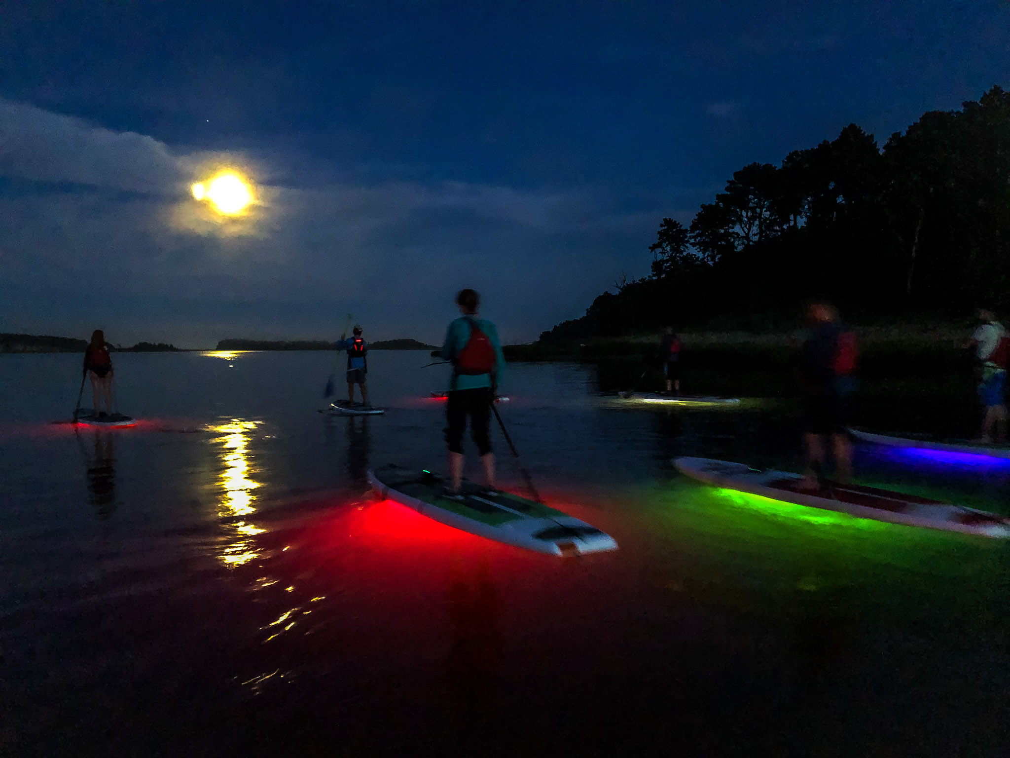 Paddleboarding under a full moon 