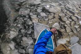 Paddling through the icy waters in a drysuit